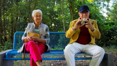 two non-young people on a bench thumbnail hero image